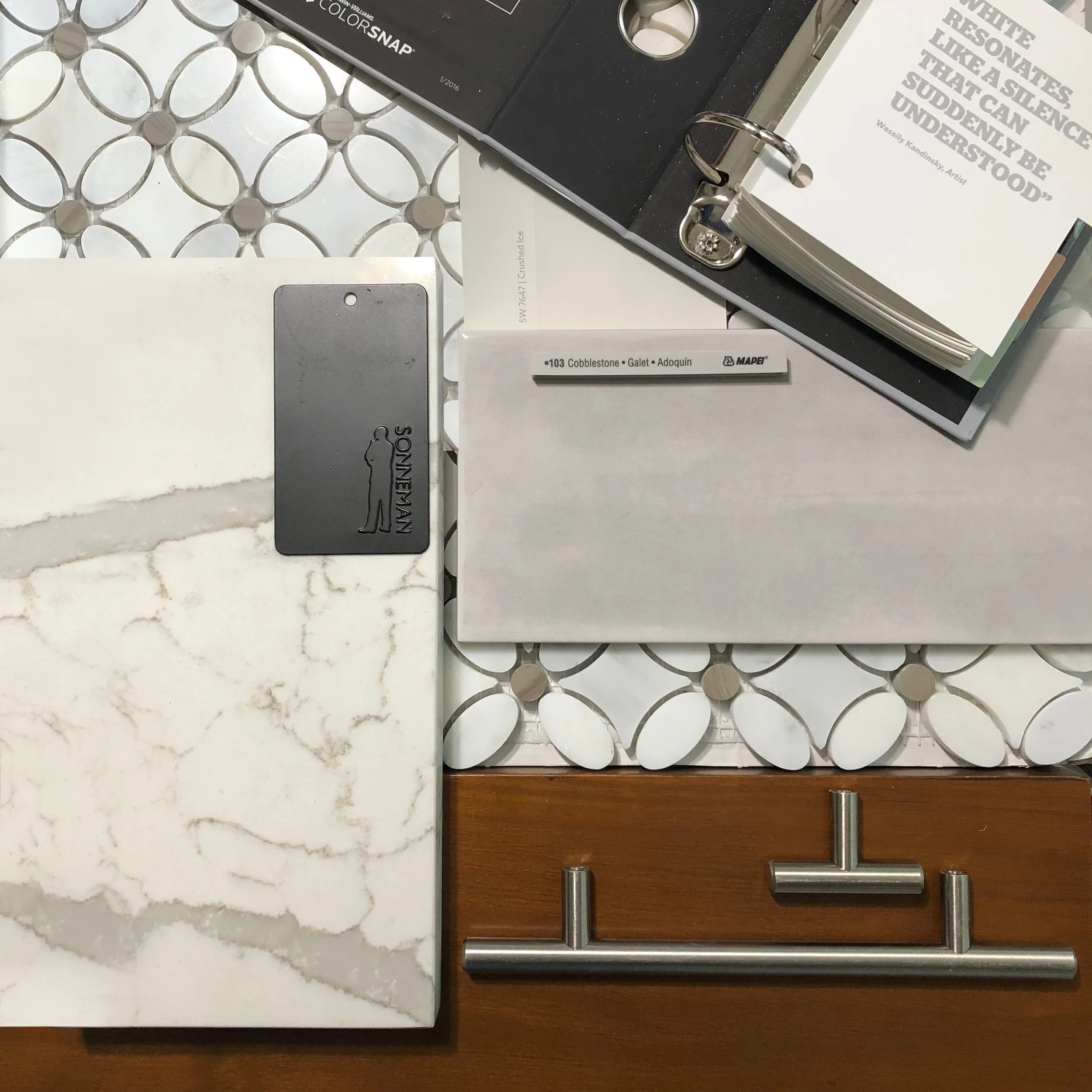 Master bathroom materials palette: neutrals with accents of wood and black finishes.
