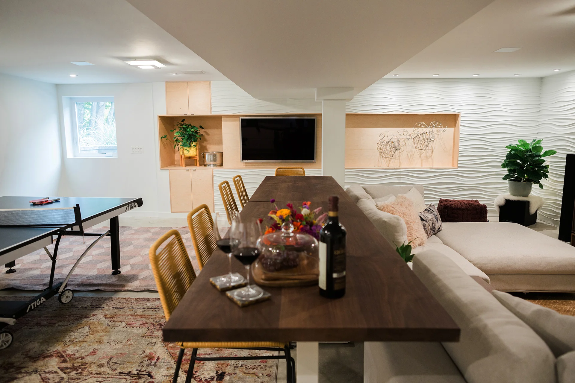 A variety of spaces make up this basement, from a ping-pong game area to comfy seating. {Photography by Olga Polo Photography}