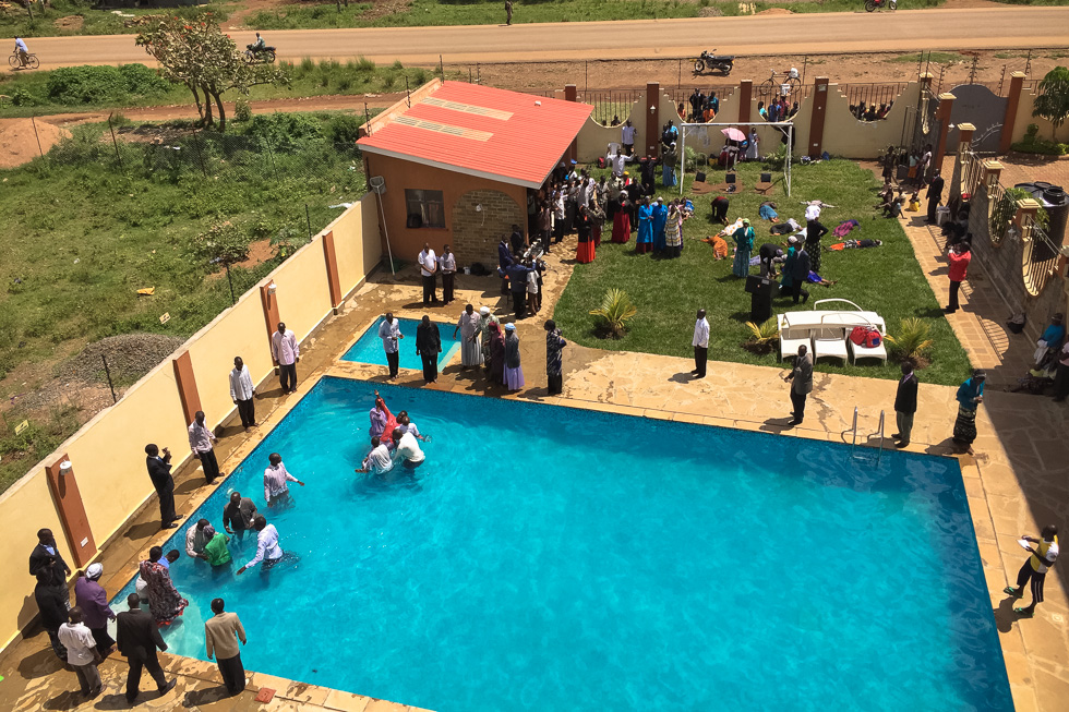 A religious ceremony takes place in the pool of the town's only hotel. Migori, Kenya, December 2015.