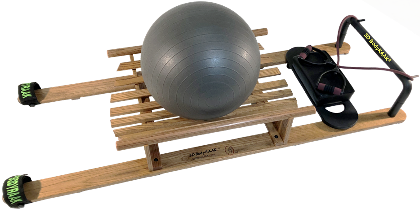 A wooden sled with slats, a large gray exercise ball, and a black fitness rowing machine with pink accents on a white background.