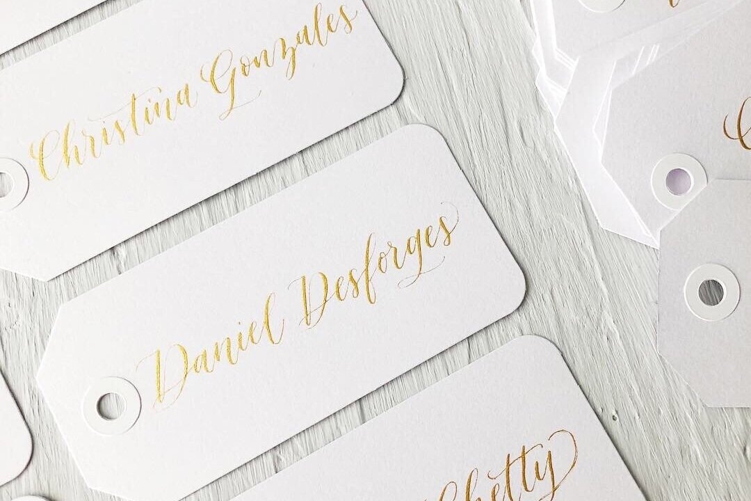 Gold calligraphy on place cards