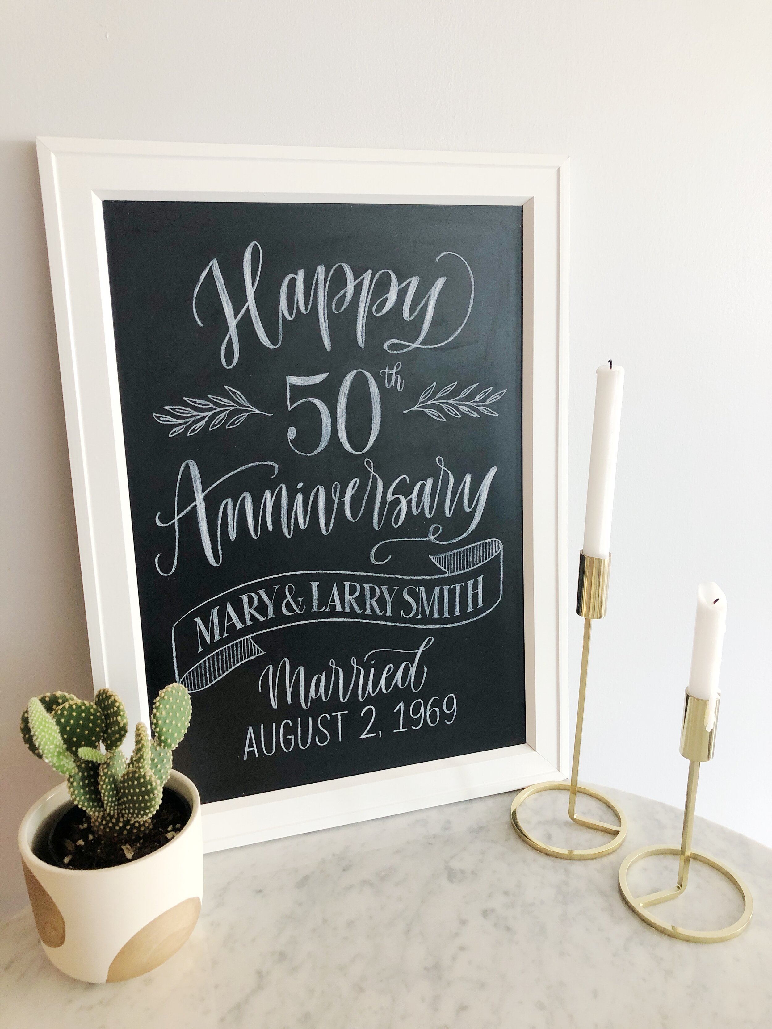 Custom chalkboard sign featuring a 50th wedding anniversary celebration
