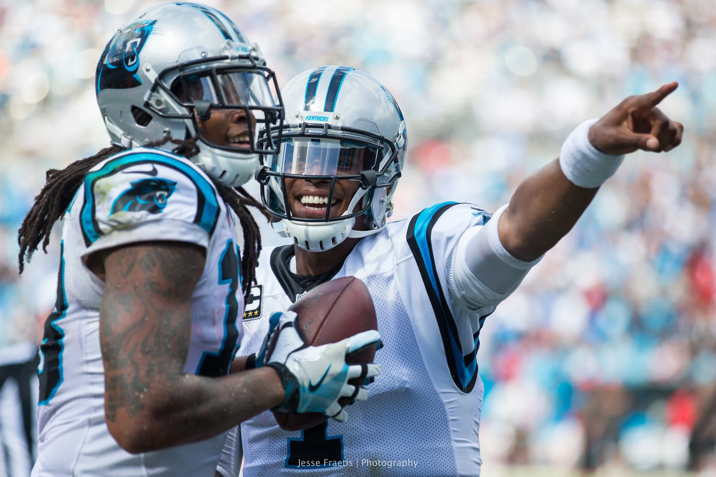 Cam celebrates with his star WR and encourages him to give the ball to a fan