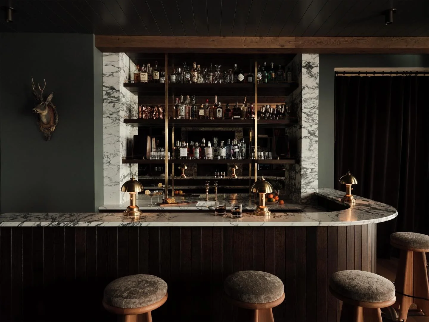 A before and after for the books.
What was once a lacquered wood &ldquo;mountain theme&rdquo; bar has been completely reimagined into what might just be the best bar in town. The Montana Maison bar transformation trades glossy wood for moody lighting