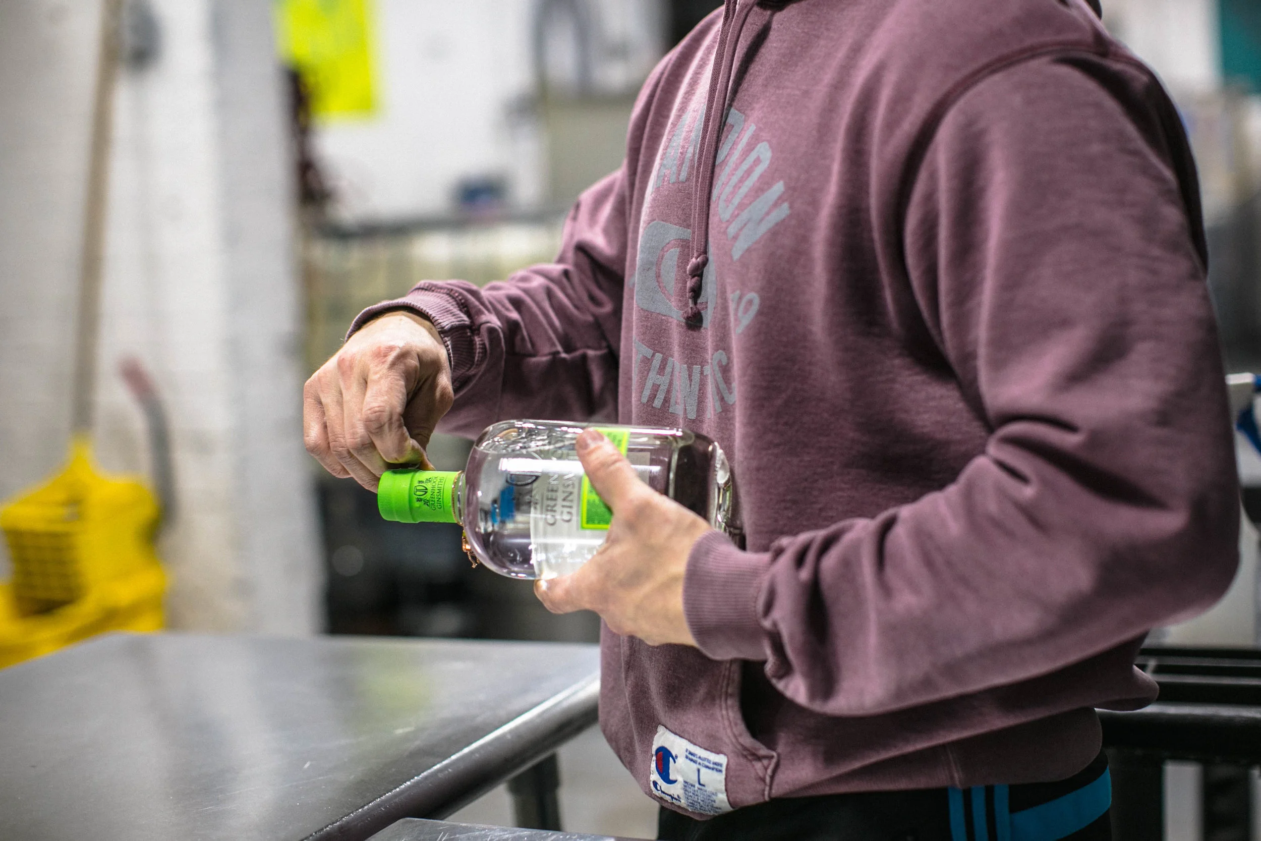 Each hand-labeled bottle of Greenhook Gin undergoes a quality-control check before leaving the distillery.