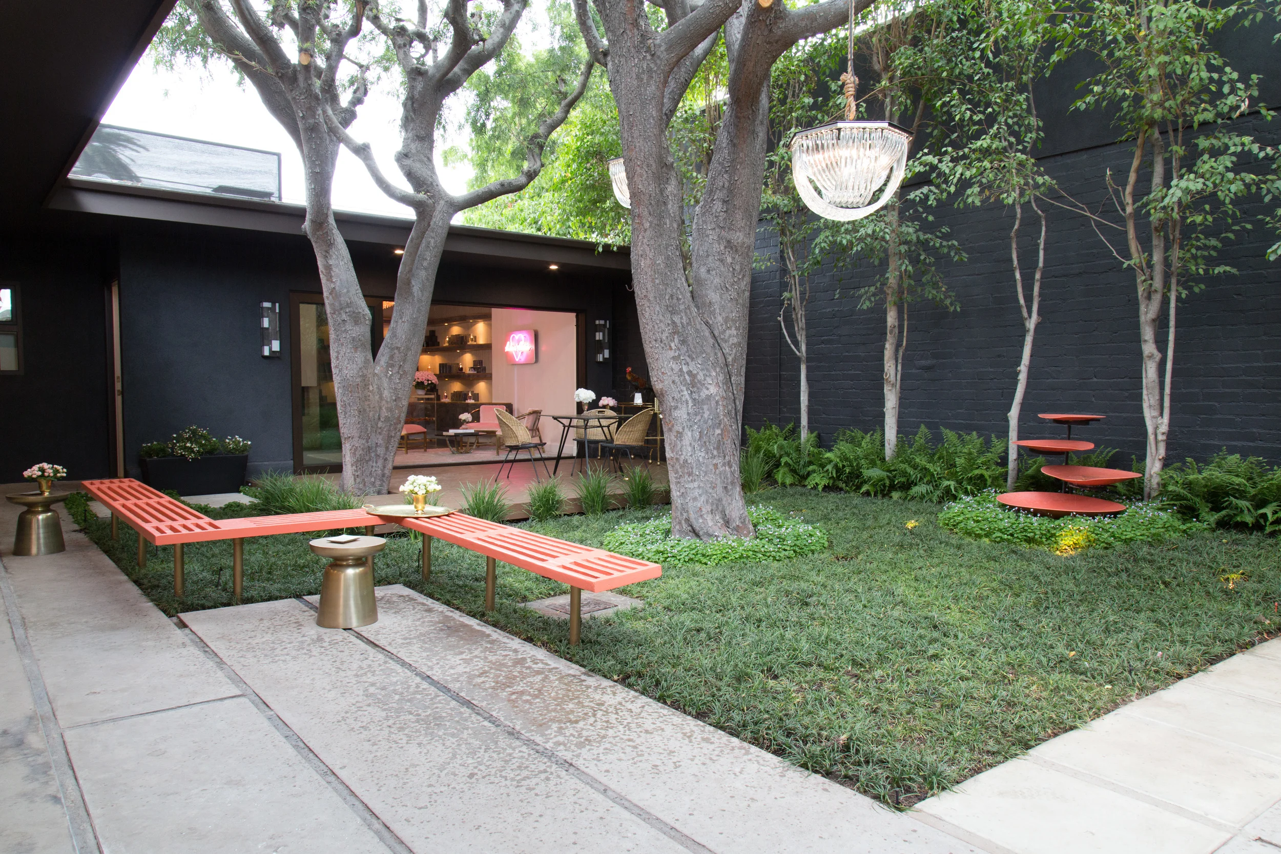 The Courtyard is a critical component of the complex. It functions as both a unifying and independent space at the same time. It provides the main access into each space and thus ties each component to one another through the underlying idea of openness and floral scents. It is planted with each flower varietal that the fragrances use as their main component. The deck is often used as the stage for performers while the courtyard becomes their venue.