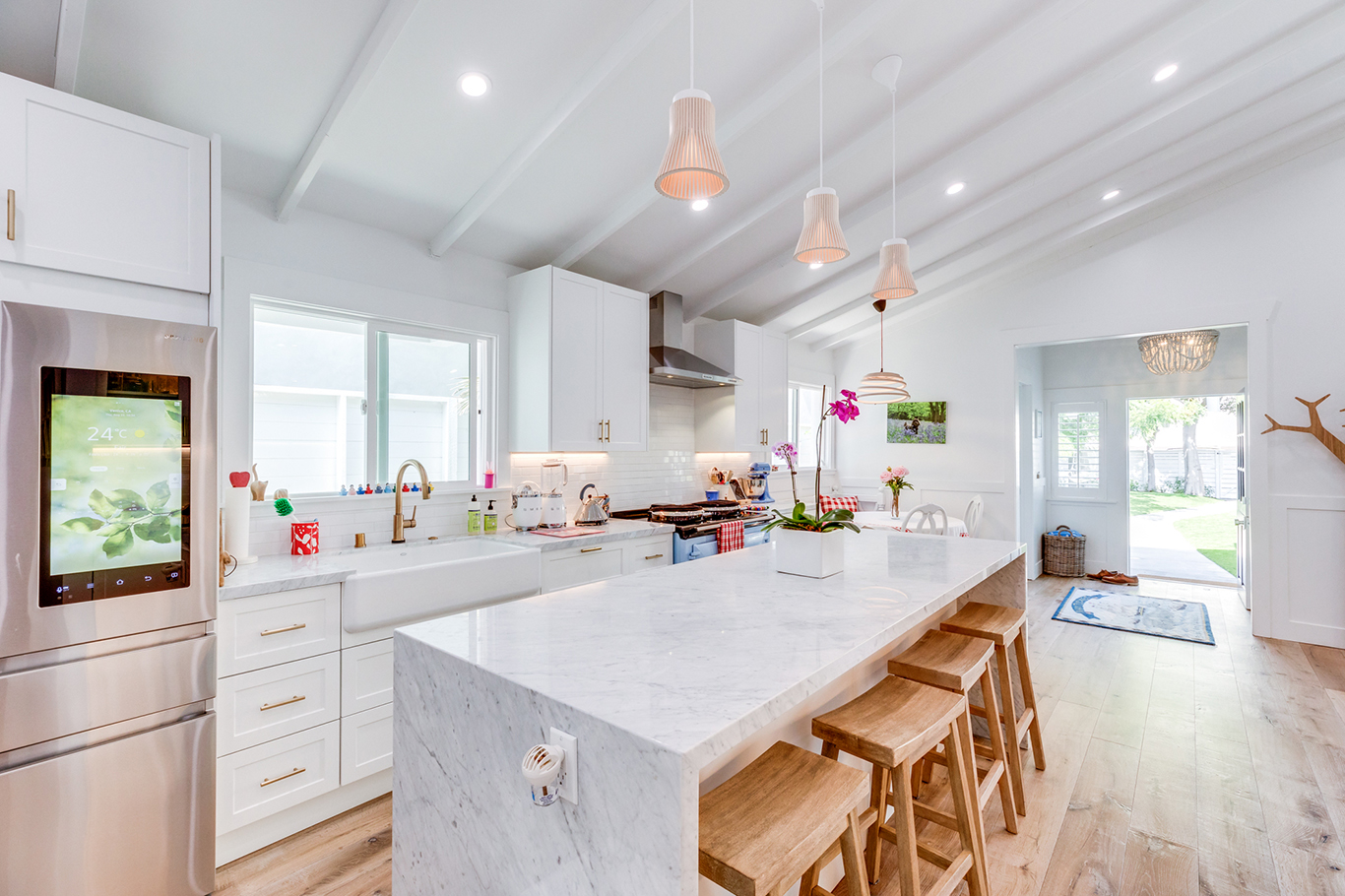 The kitchen takes the place of the original living room. As a central feature of the home, the kitchen connects the entire space and is complete with new floors, hardware, and fixtures.