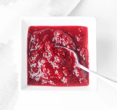 THIS COLOR. Not the purple cranberry sauce you plop out of a can — the pinkish red cranberry sauce you plop out of a plastic box from Kroger's prepared foods section. (The fancy kind.) Image via .
