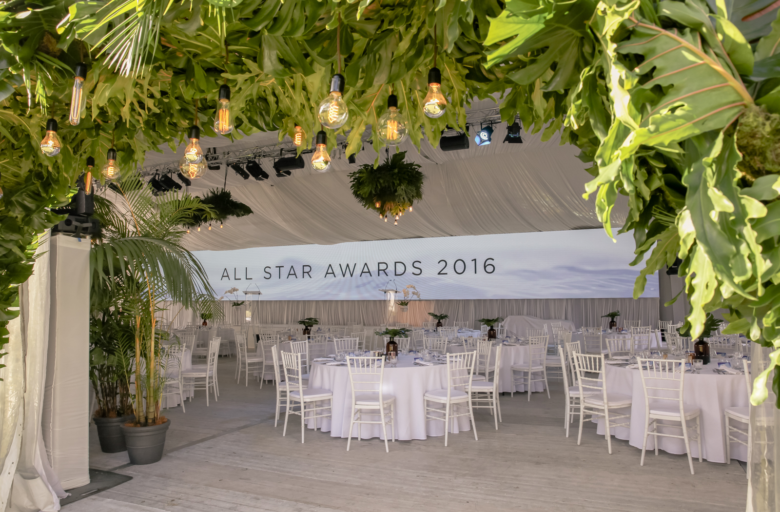 Covered archway and hanging foliage chandeliers for Unicorn Group awards gala dinner at Elements of Byron resort