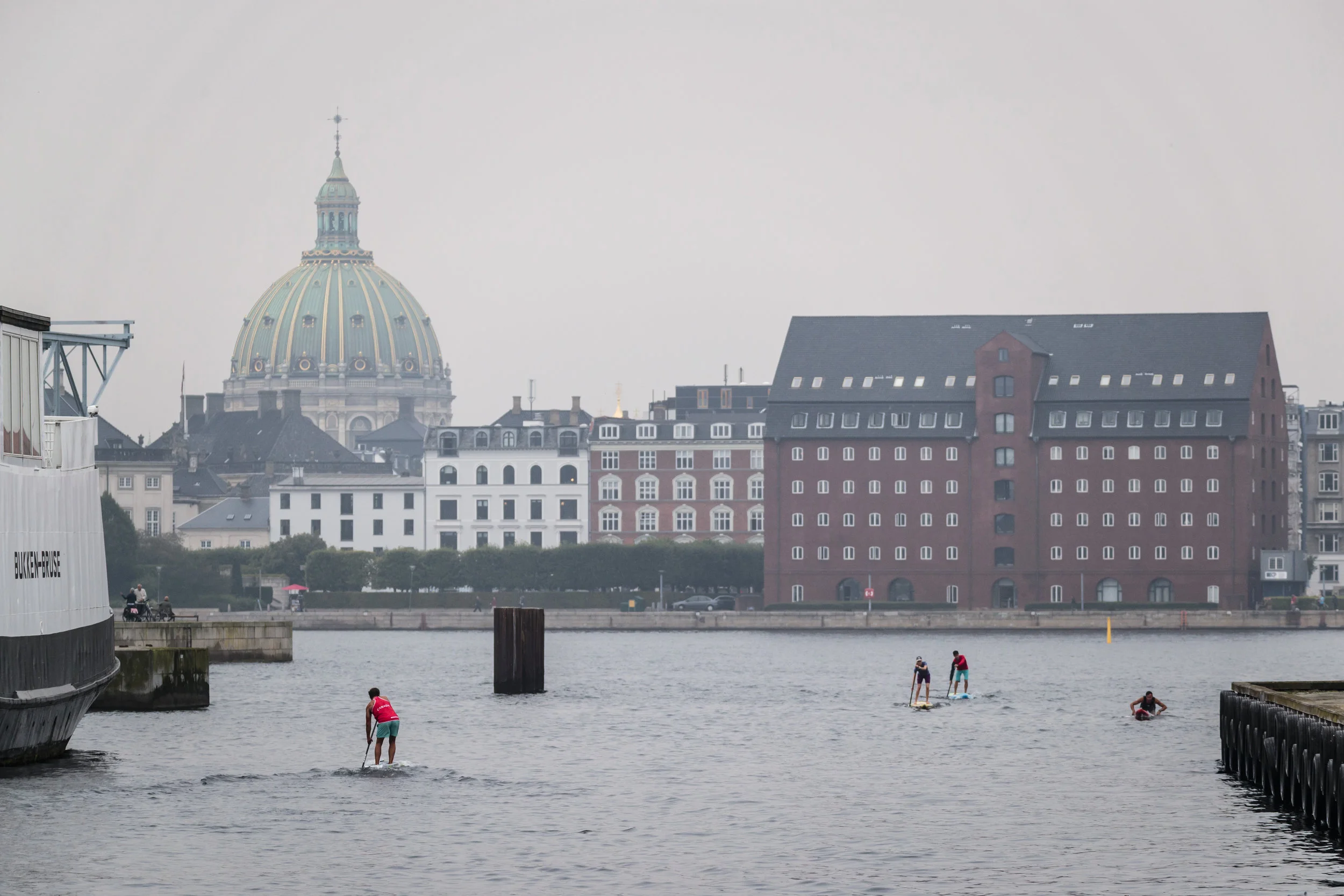 SUP and Paddleboard Racers warm up in Copenhagen Harbor for the Distance and Sprint Races to come on Saturday and Sunday. Photo: ISA / Ben Reed