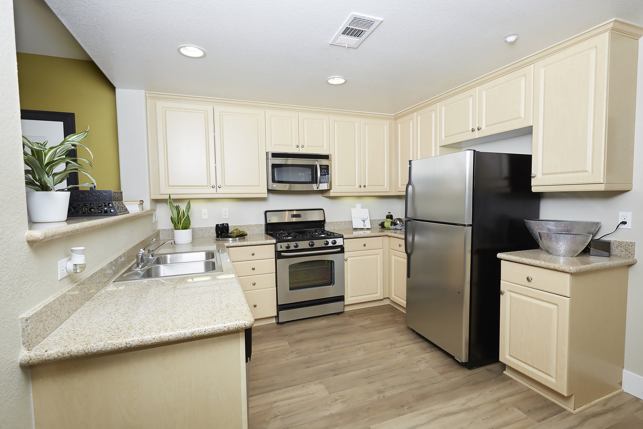  The kitchen with lots of cabinet space and stainless steel appliances. 