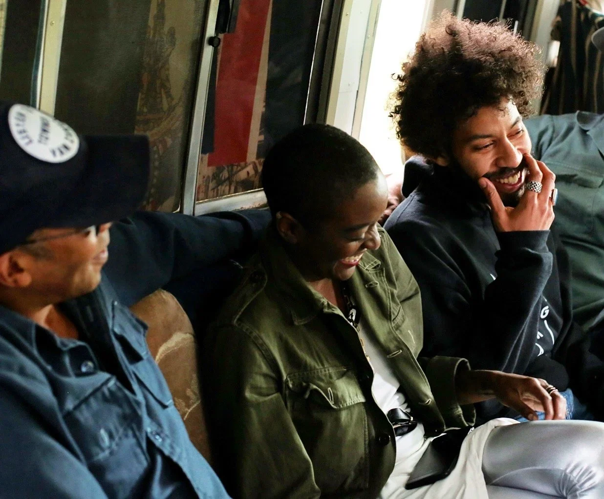 People enjoying a conversation inside the Gratitude & Dream buses.