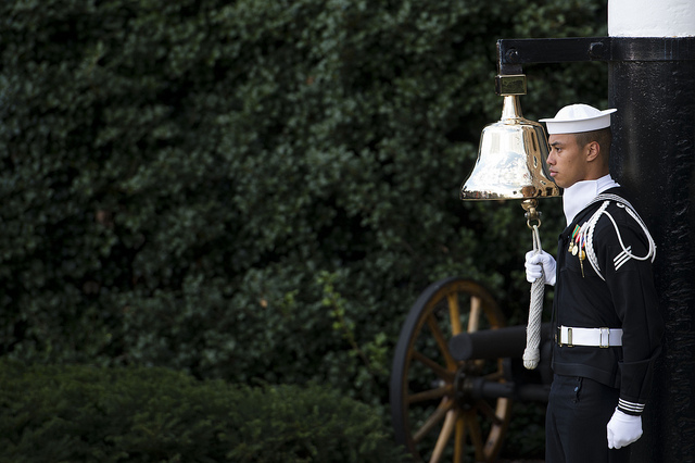 A sailor rang the bell each time the names of a fallen victim of the Navy Yard shooting were read during a memorial ceremony at the Marine Barracks in Washington D.C. Photo via Erin A. Kirk-Cuomo.