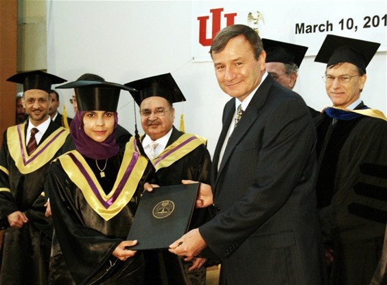 U.S. Ambassador to Afghanistan Karl Eikenberry presents a graduate with her Master's of Education diploma. ( USAID ) 