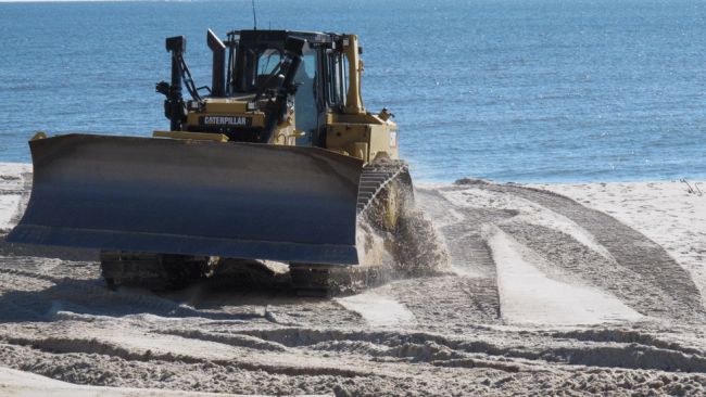 A bulldozer works on a New Jersey beach. 