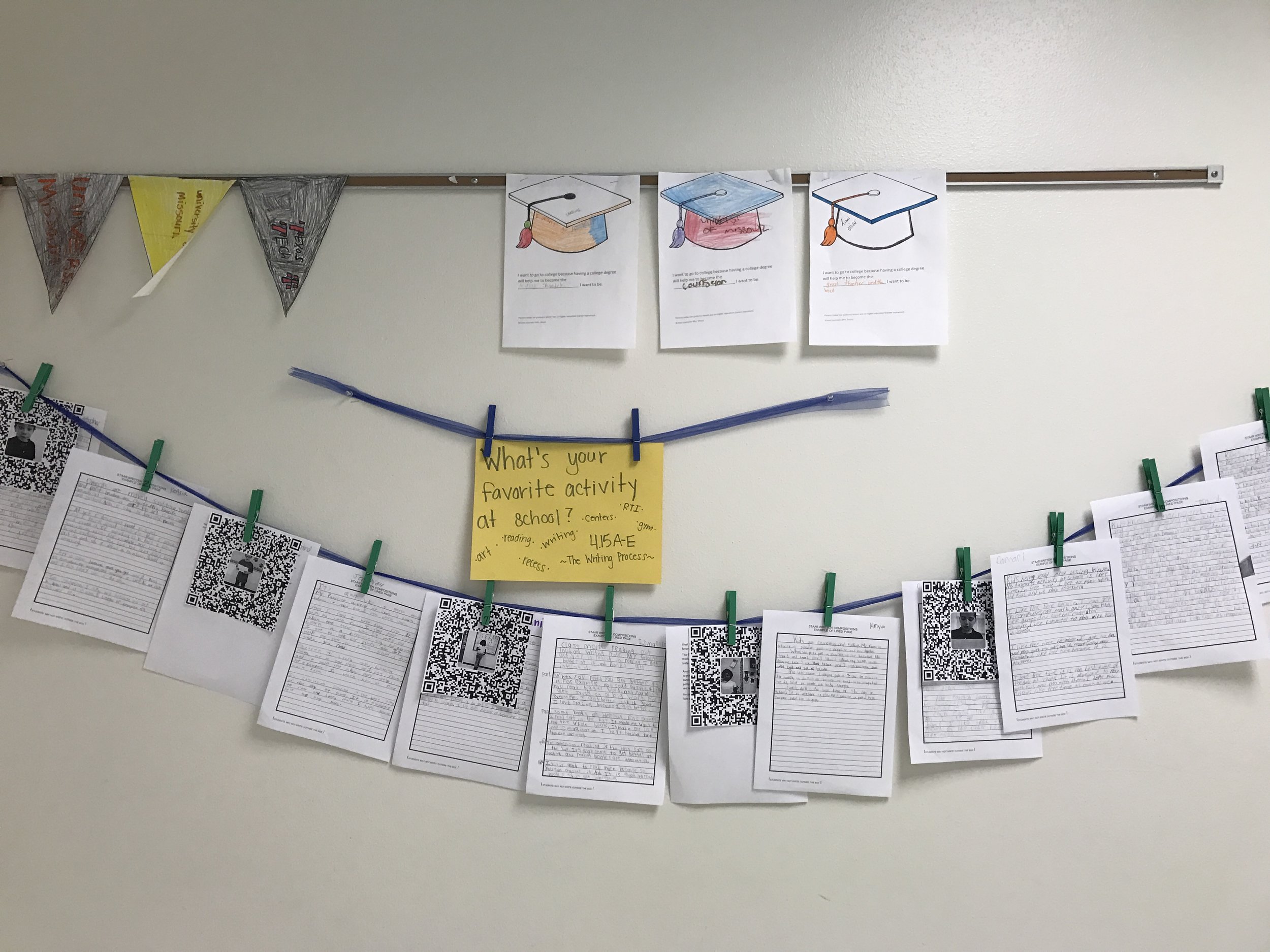  This teacher used their bulletin board to show off student work with QR codes that link you to an audio clip of the student reading their story. 