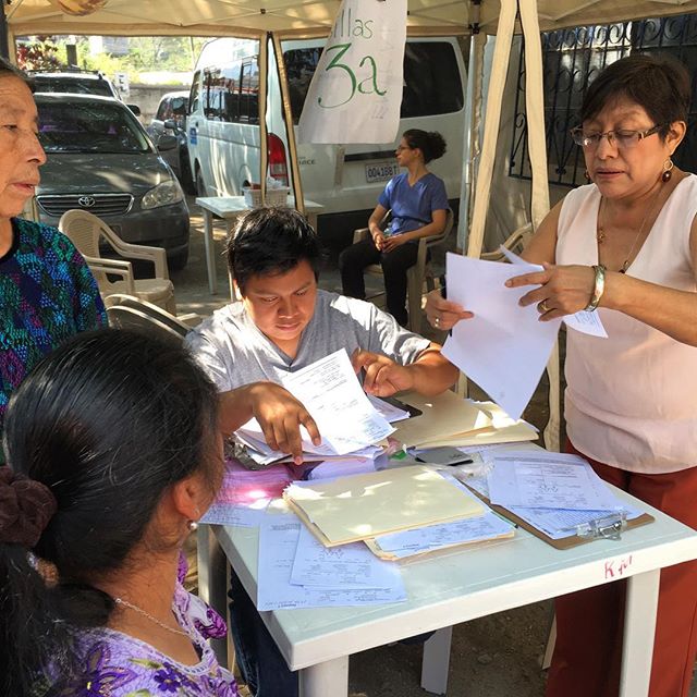 Helen and Gerardo keep registration moving during IHP's April volunteer acupuncture mission to Panajachel Guatemala