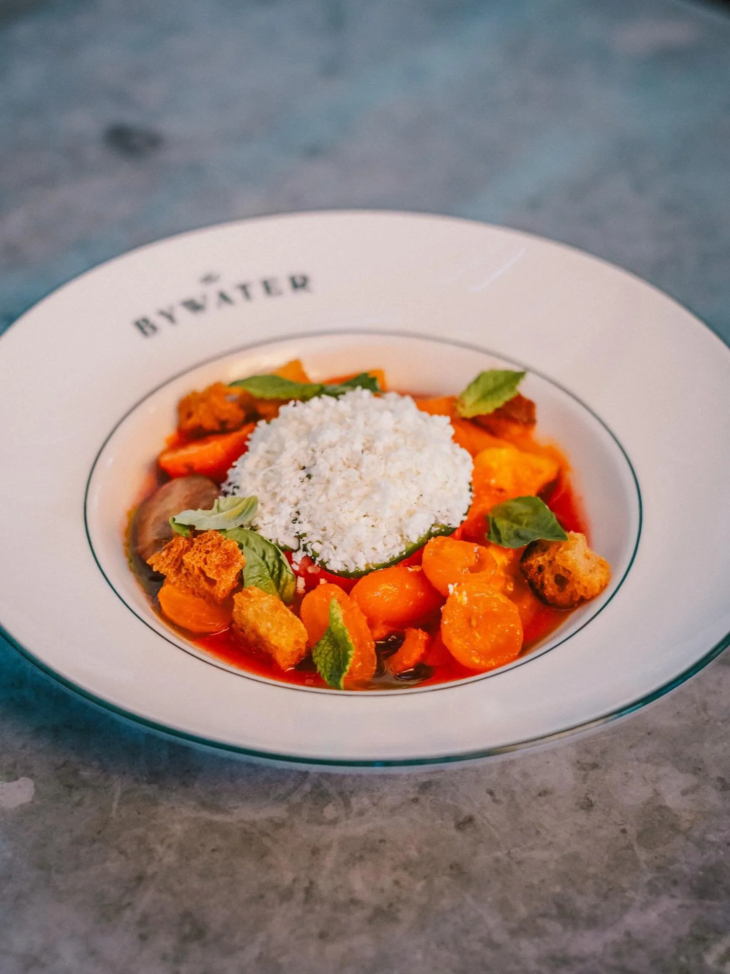 TASTES OF THE SEASON our tomato watermelon salad is a summertime gem. Dressed in watermelon juice, tomato vinaigrette, and basil oil with fresh mint and shaved frozen feta. The Summer in Oaxaca brings together peaches, tamarind and Mezcal. Bright and