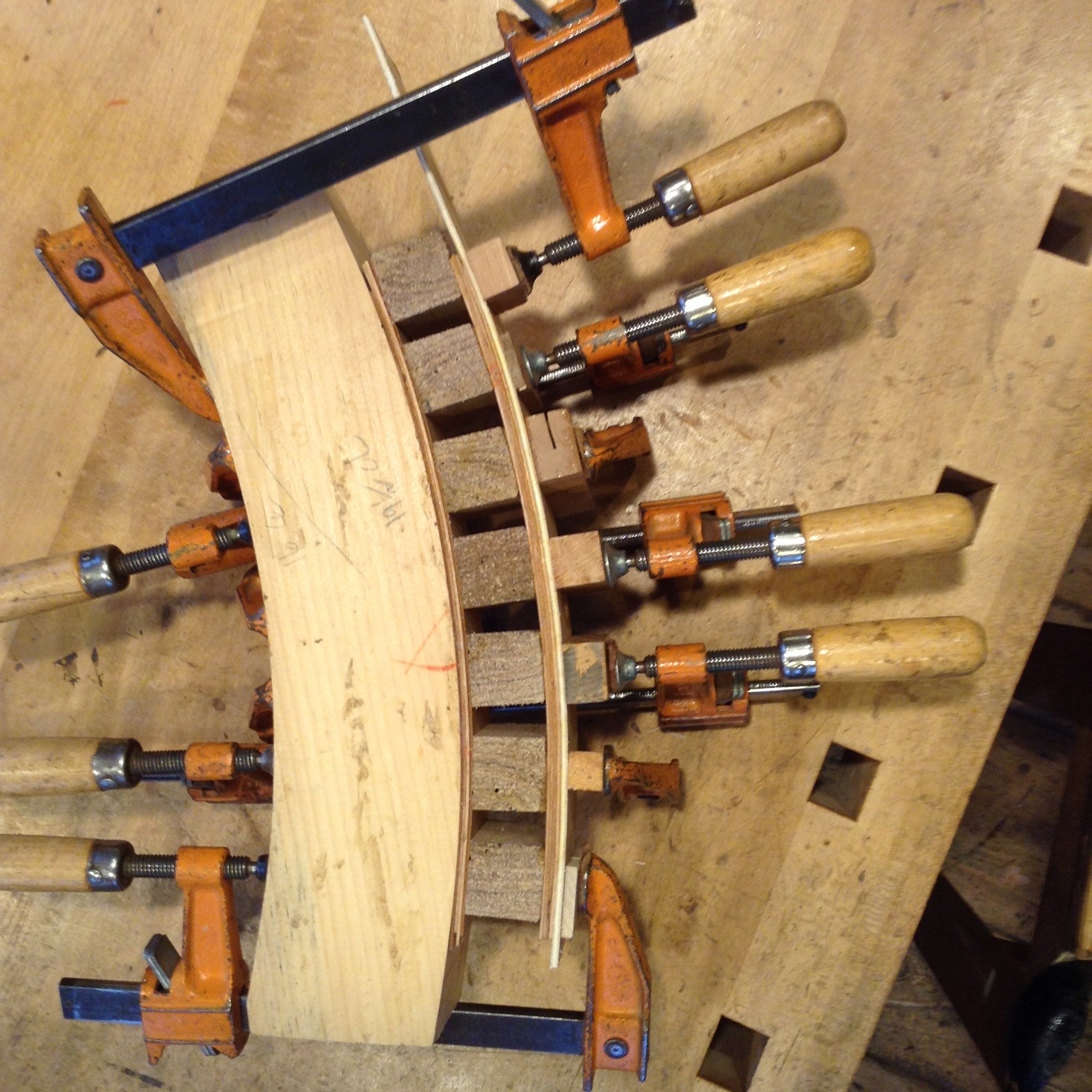 A simple solution to bending two parallel drawer sides — separate them with blocks equal to the inside width of the drawer.