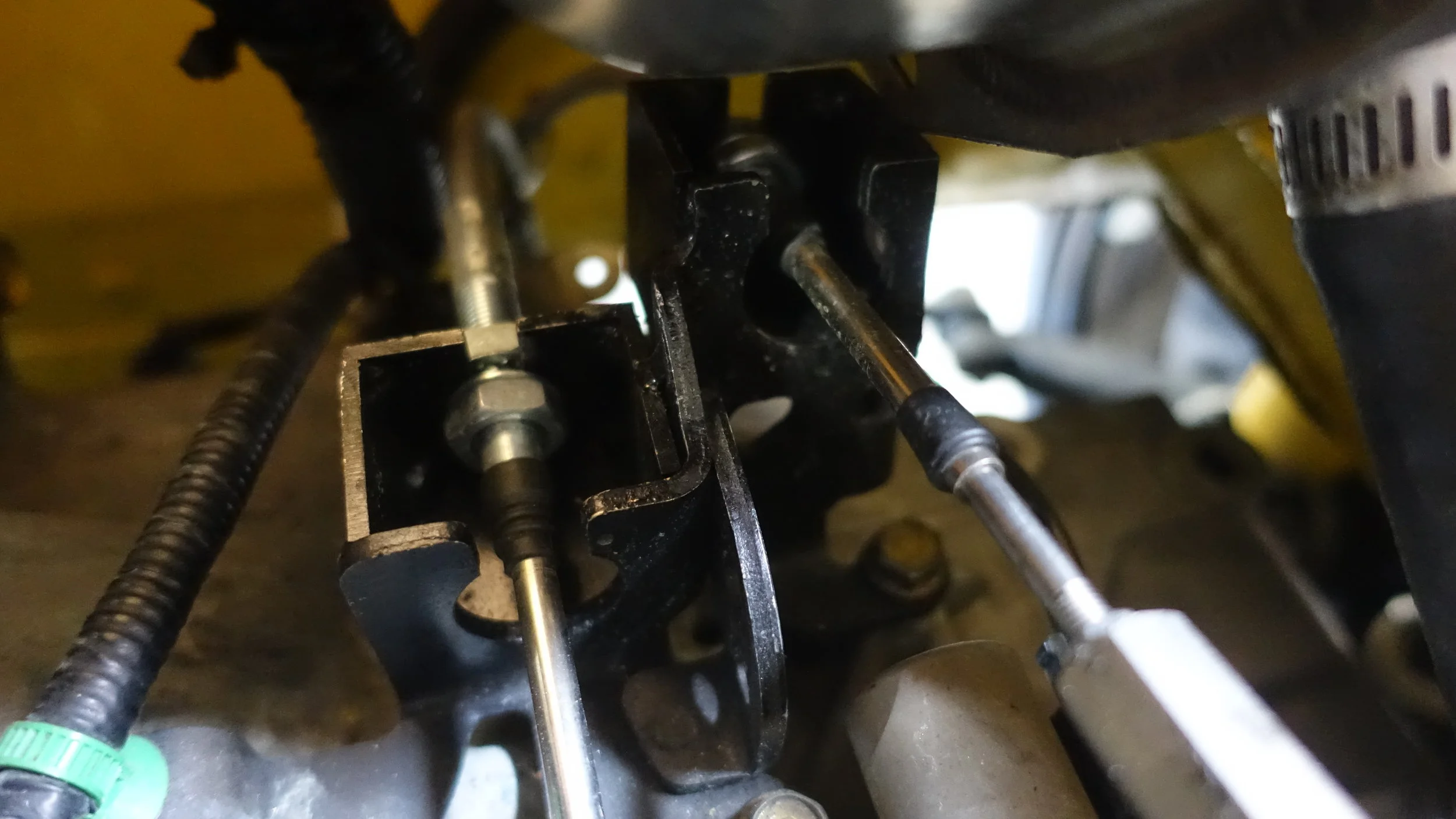Custom made shift cable brackets at the transmission end.