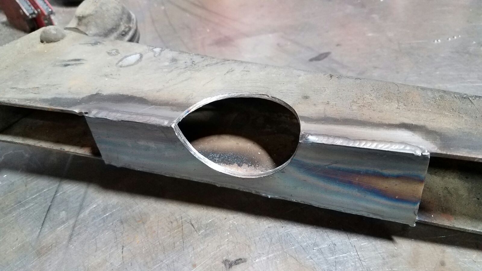 The left lower control arm needed to be notched for transmission clearance. A steel plate was then welded in for reinforcement.