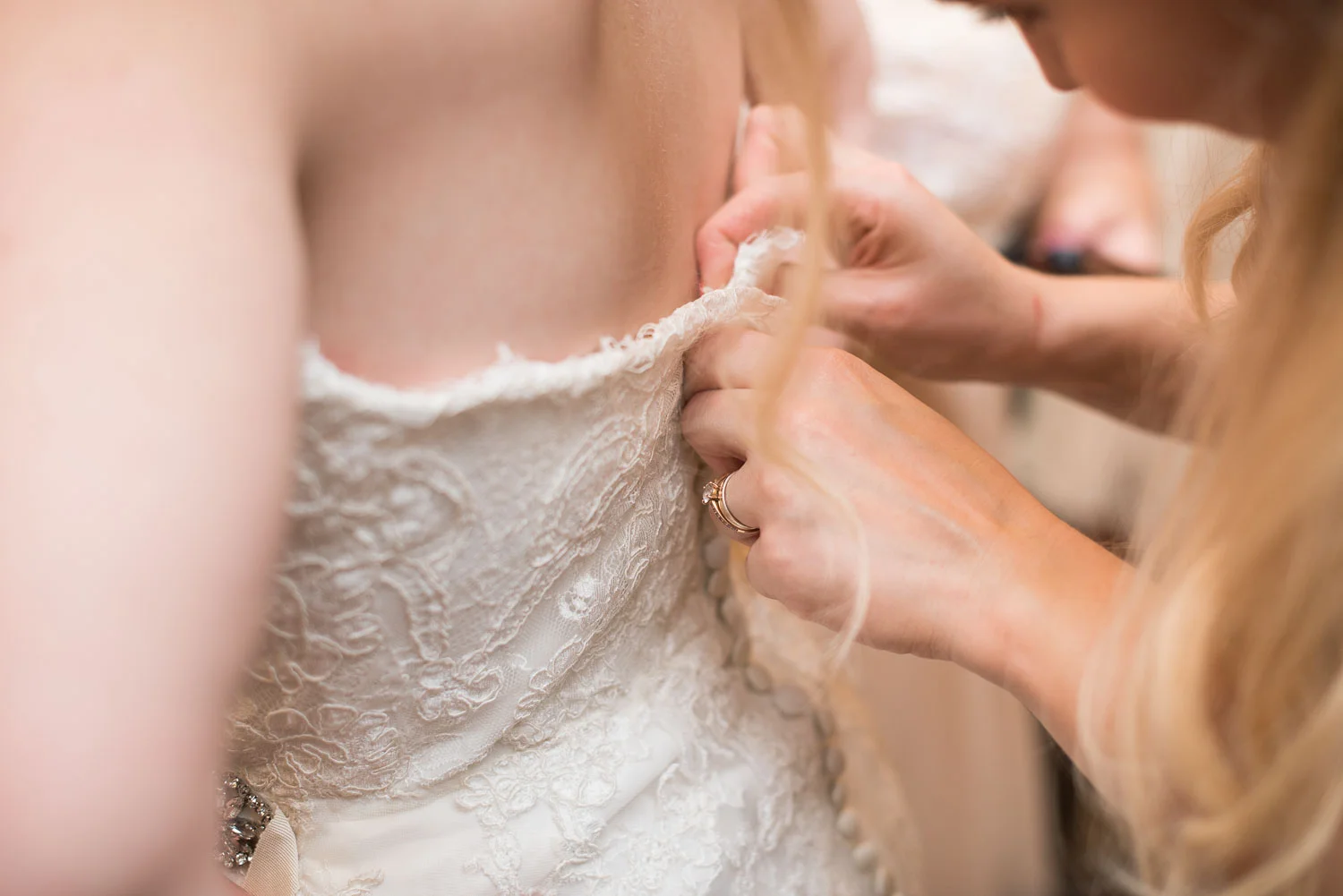 14 bridesmaids help zip up the bride's dress.jpg