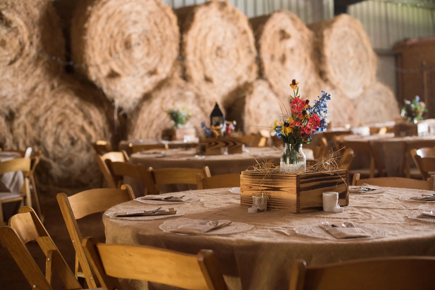 63 wedding reception in barn with hay bales.jpg