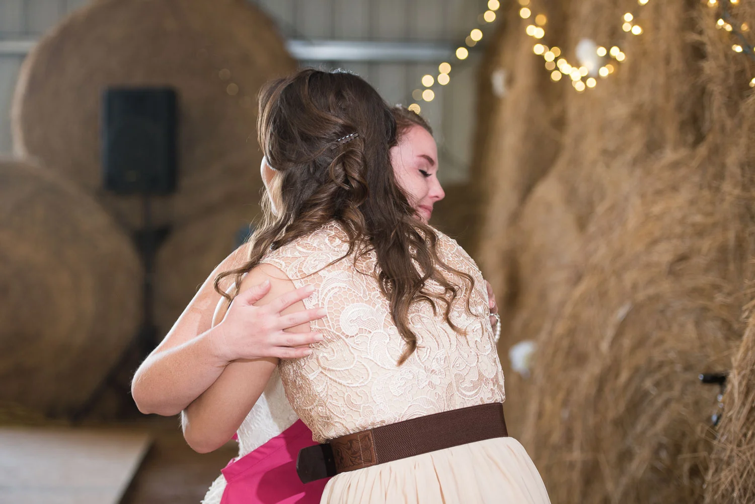 83 bride and maid of honor hug after her speech.jpg