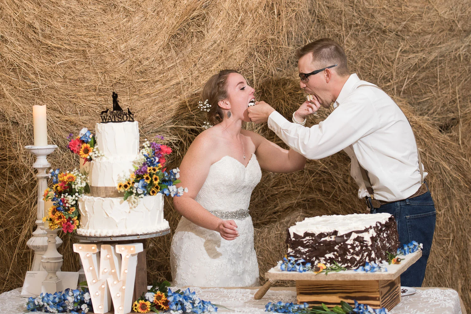 119 couple sharing their first bite of cake during reception.jpg