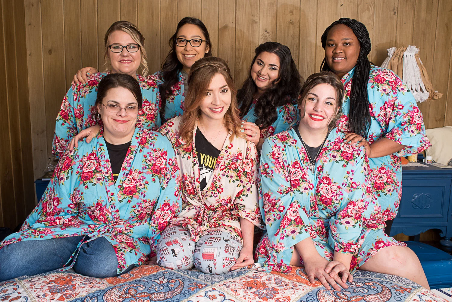 28 bridesmaids in matching robe on bed.jpg