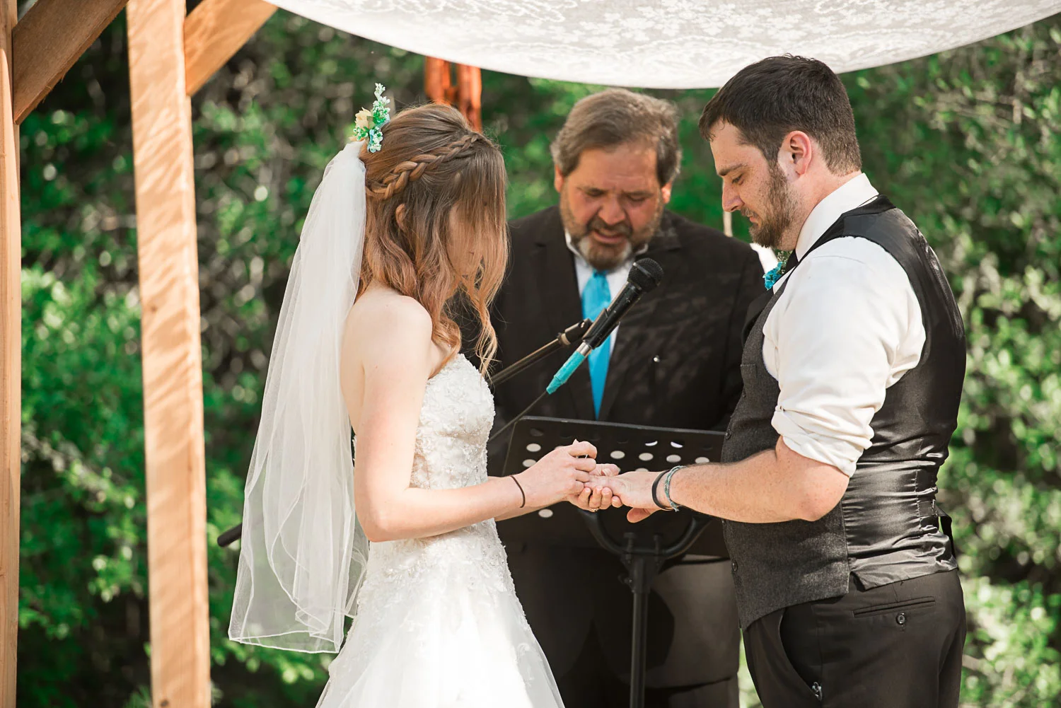 75 bride puts on grooms ring.jpg