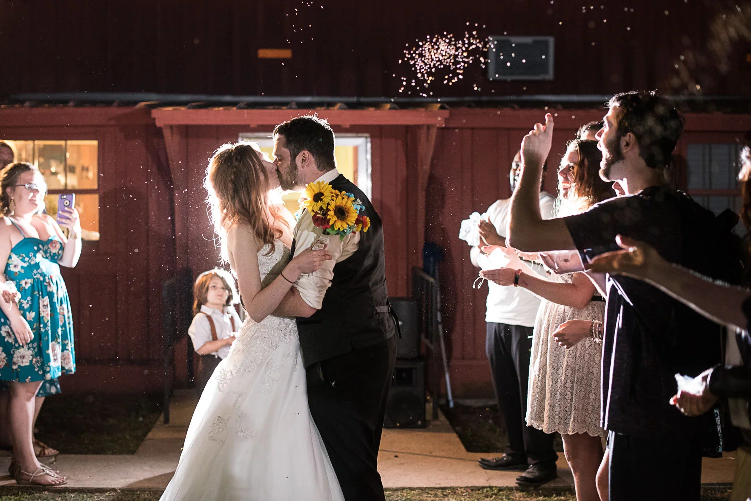 198 bride and groom exit with birdseed at night.jpg