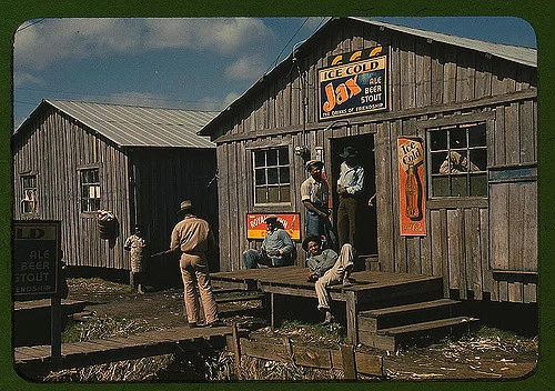 Migratory laborer outside of a "juke joint" during a slack season, Bella Glade, Florida. Photographed by Marion Post Wolcott.
