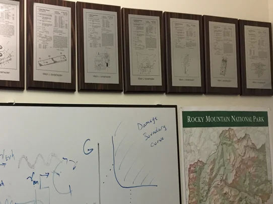 Patent plaques, whiteboard calculations, and plans for the next adventure.