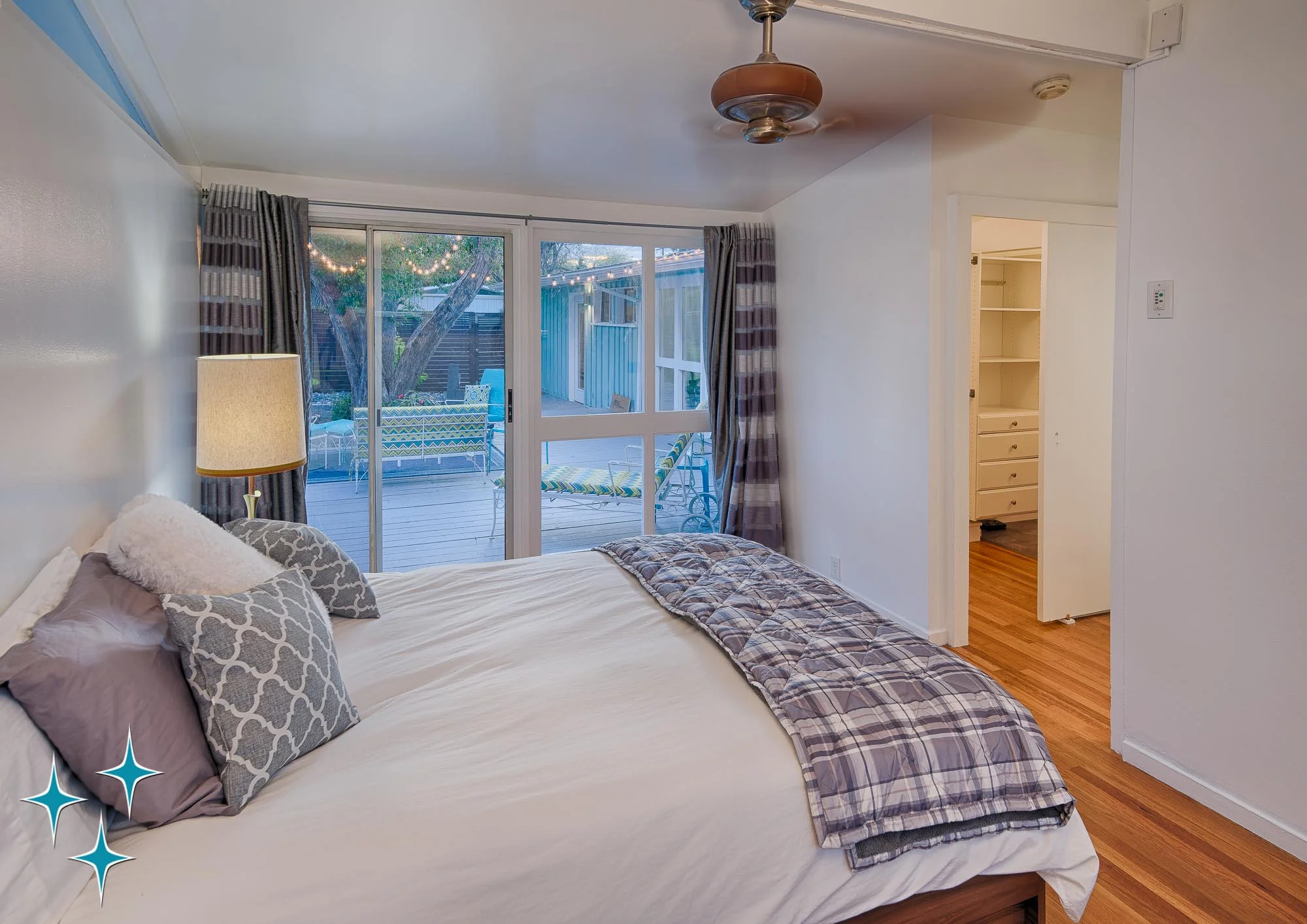 2500 S Meade Street, a Cliff May Home in Denver’s Harvey Park offered by Adrian Kinney, Broker Associate, Resident Realty South Metro. A window wall connects the master suite to the courtyard.