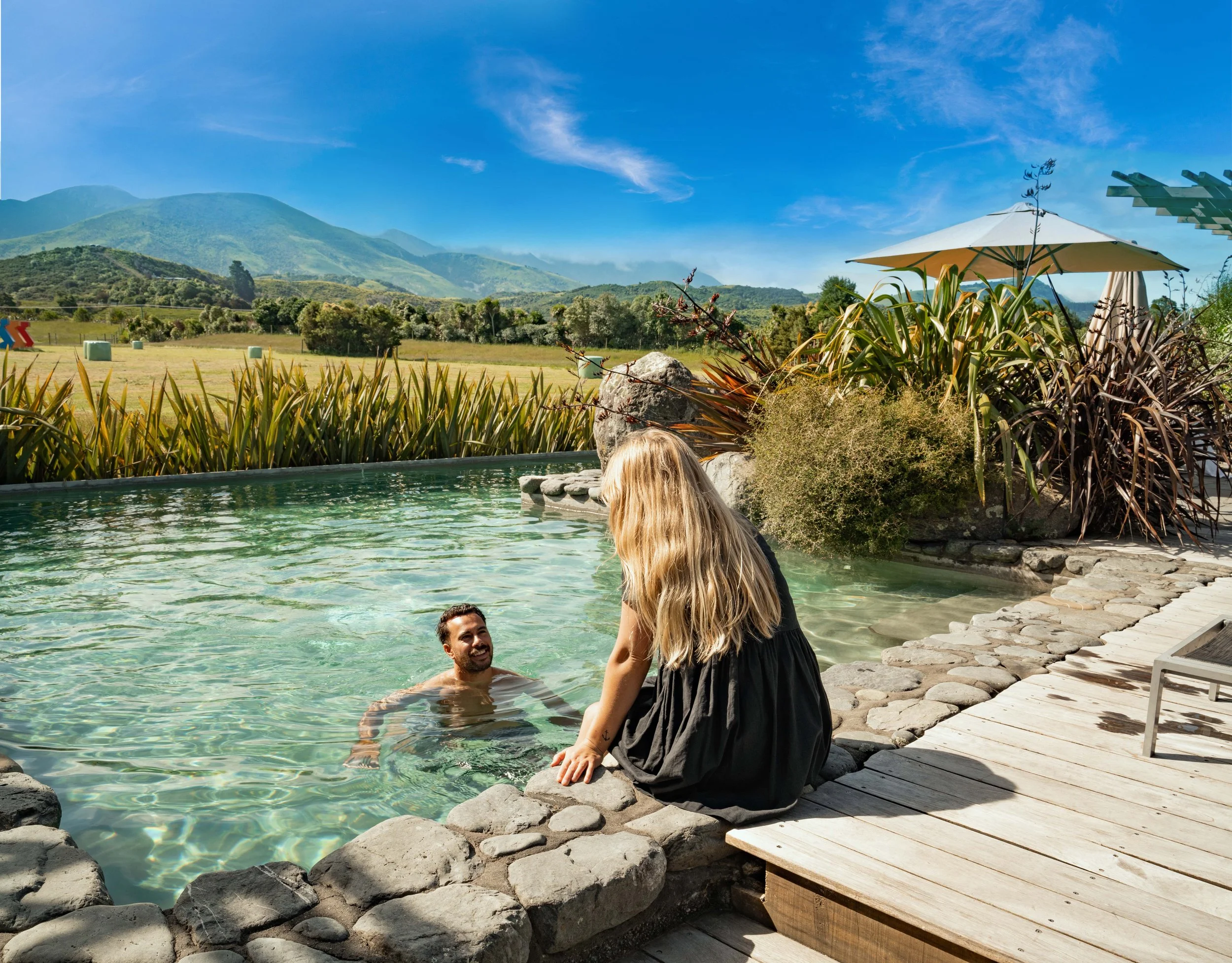 Hapuku Lodge Hero Couple Pool HAN06324 v2.jpg