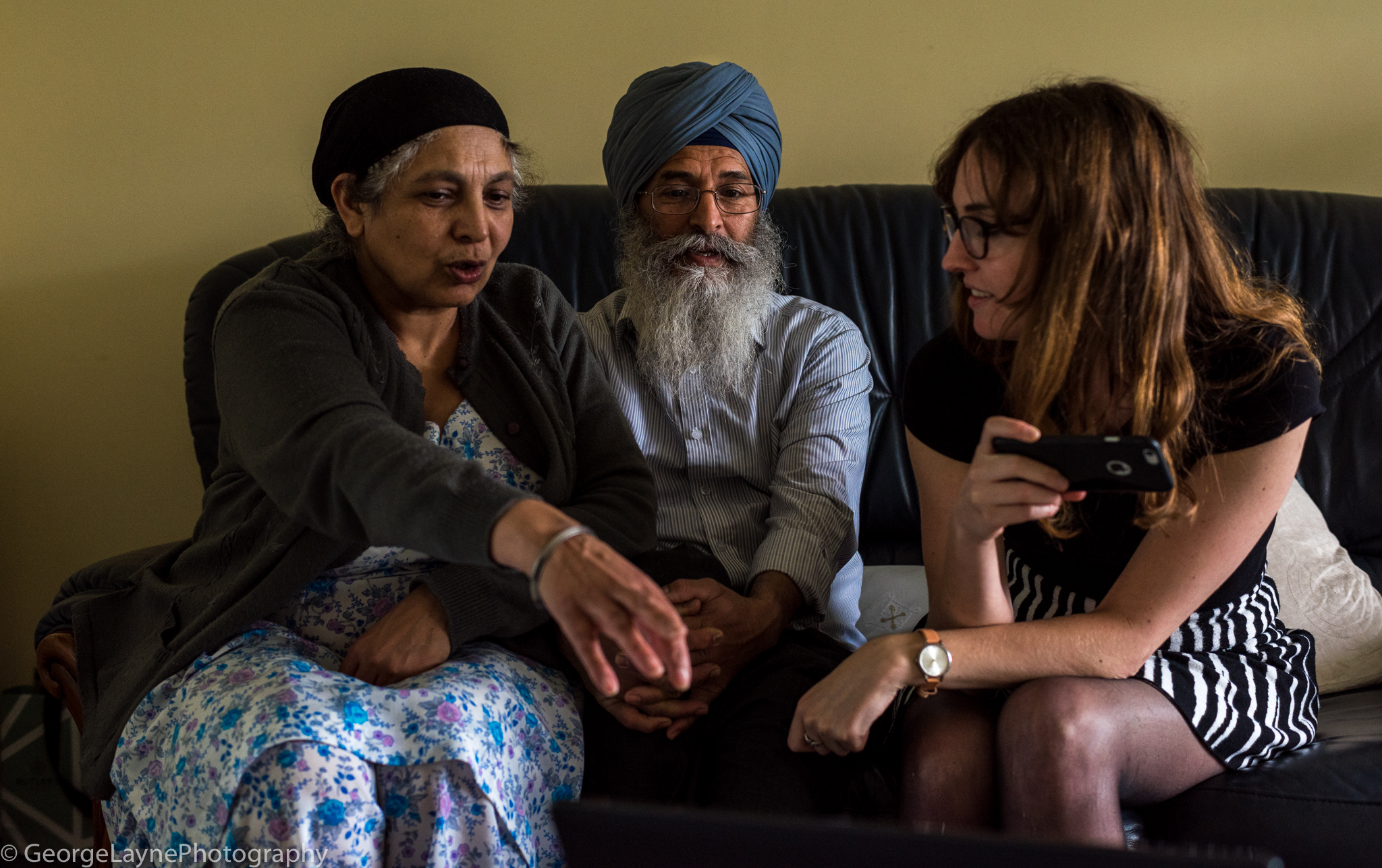 Centre: Mr. Singh. Left: Mr.Singh's wife. Right: Noelia, my girlfriend. They were looking at photos of the holiday they had spent together in my girlfriends hometown of Adra, Spain.