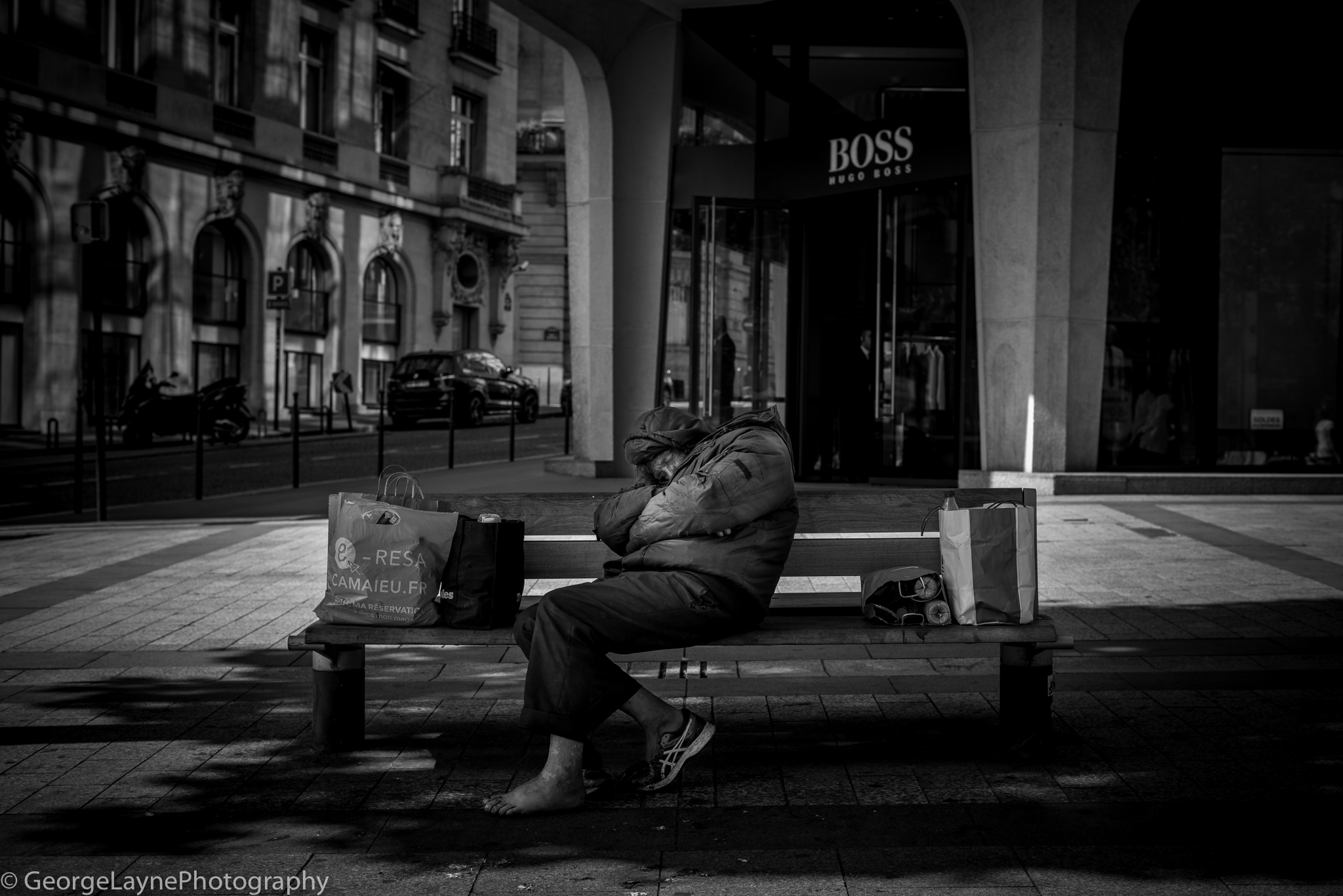 A homeless man on the Champs Élysée.