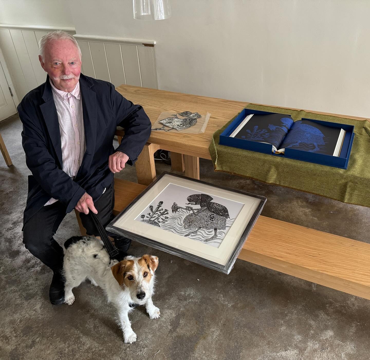 Clive Hicks-Jenkins with Rudi after delivering his exhibition to The Table which opens this Saturday 18th at 11am and on the table is Beowulf published by The Folio Society and illustrated by Clive with one of the framed original illustrations alongs