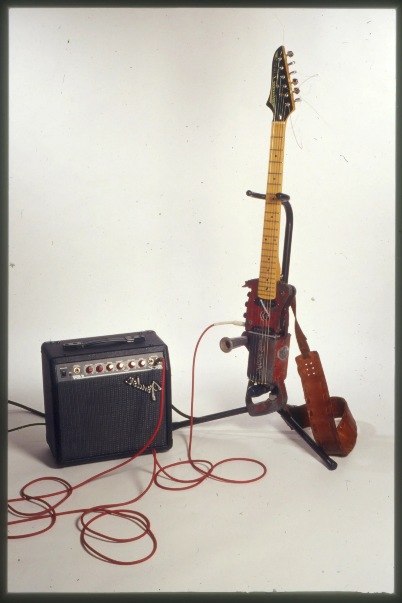  MallSawBladeGuitar - 2003 -&nbsp;guitar neck, electric chain saw, fender amplifier, stand, chords 