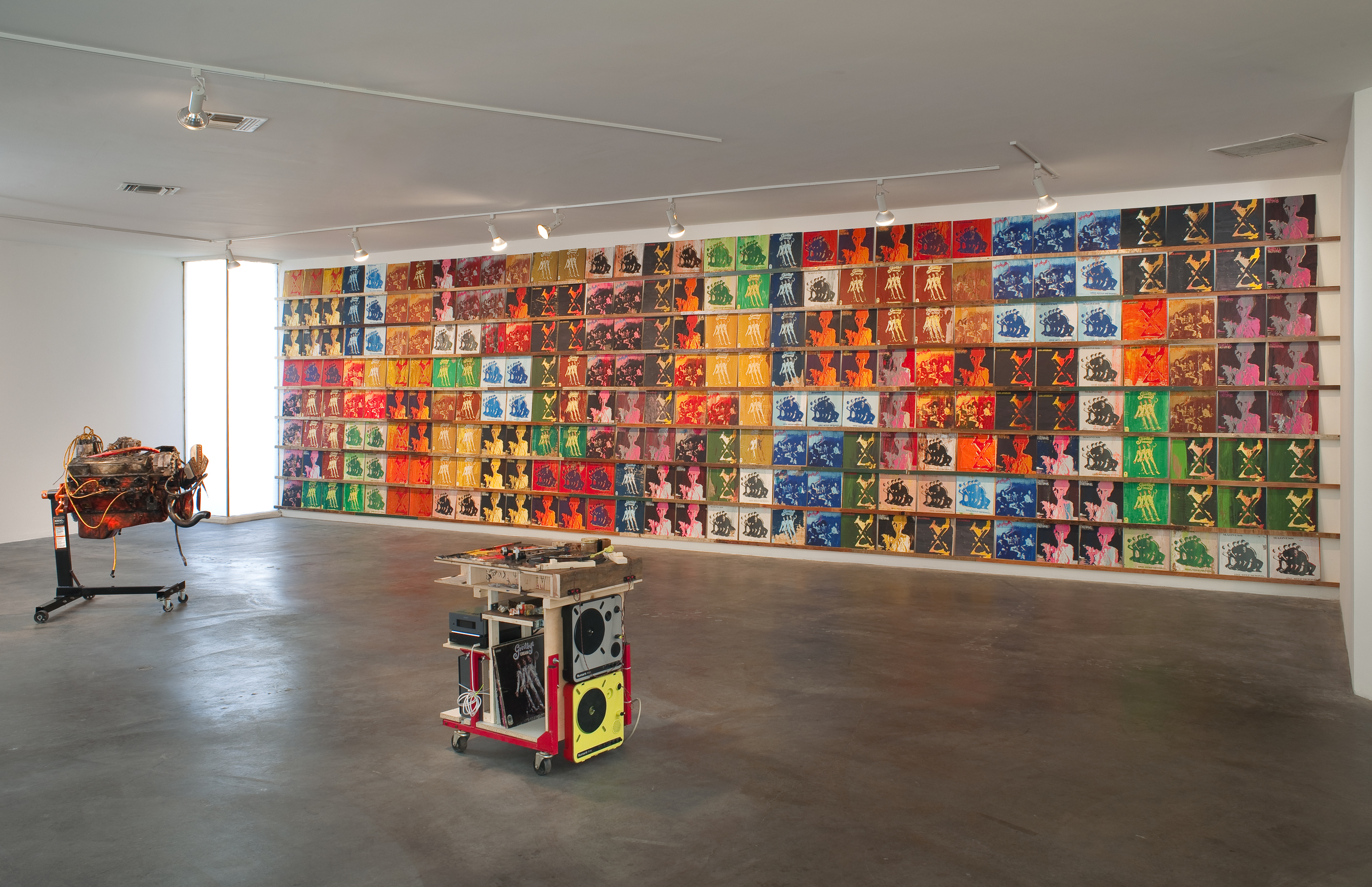 installation view with - Los Angeles - 2009 - Acrylic on scrap wood - 104” x 401” x 2” (256 records, 12” x 12” each on 8 shelves)