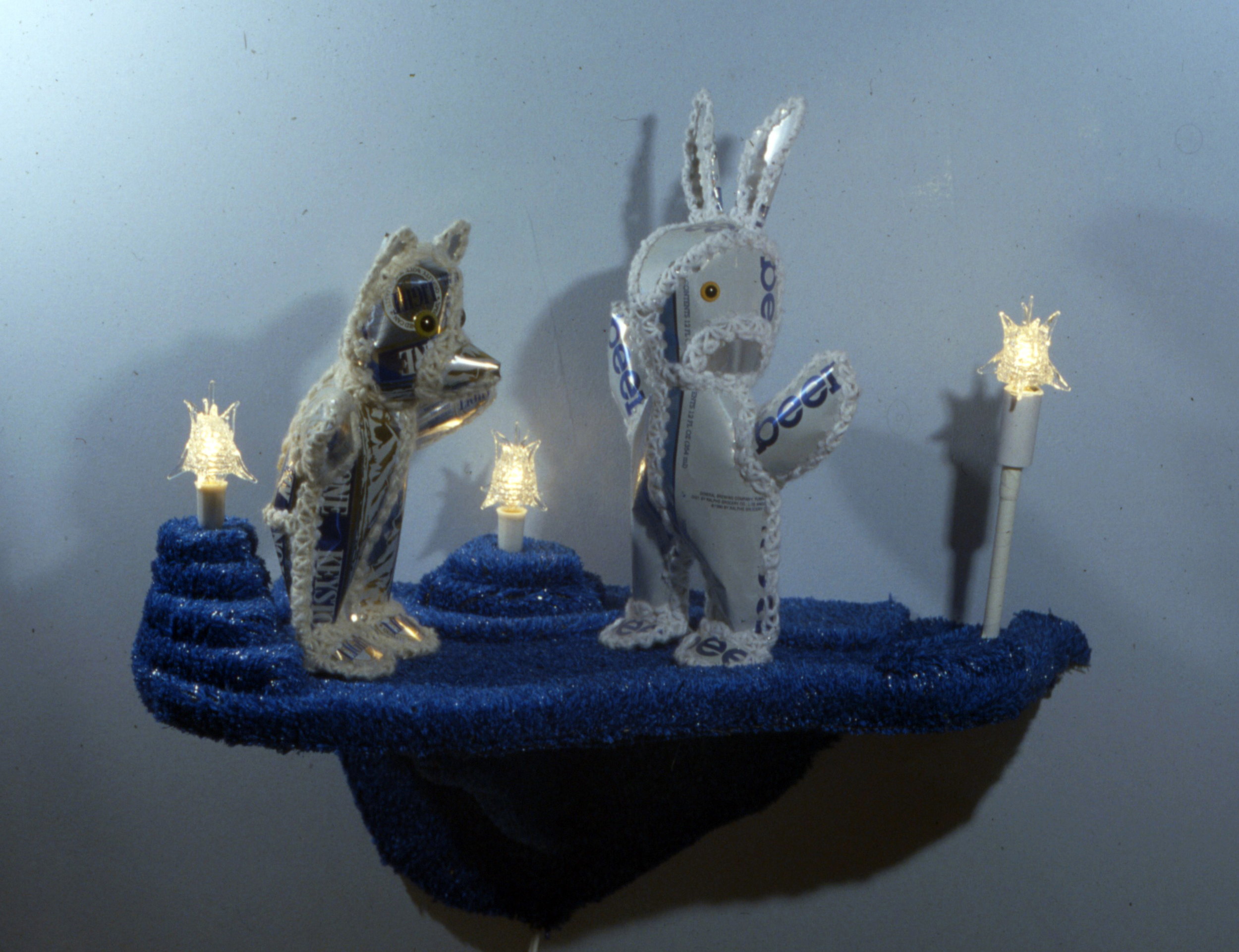 Secret Meeting in the Ice Cave - 1995 - beer cans, yarn, stuffing, astroturf, light fixtures - 18"x22"x10"