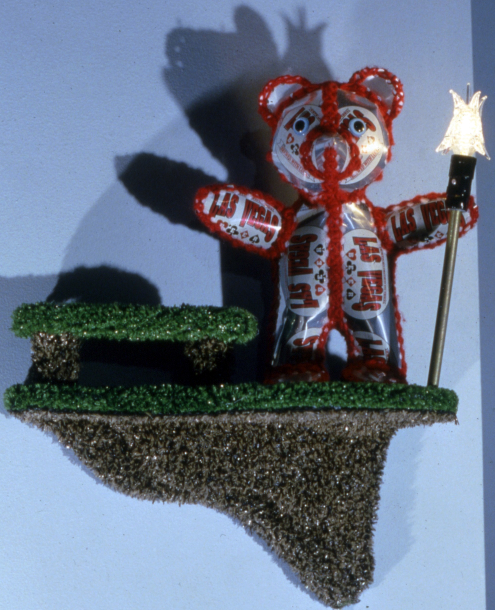 Guardian Bear (red) - 1995 - beer cans, yarn, stuffing, astroturf, light fixtures - 18"x12"x10"
