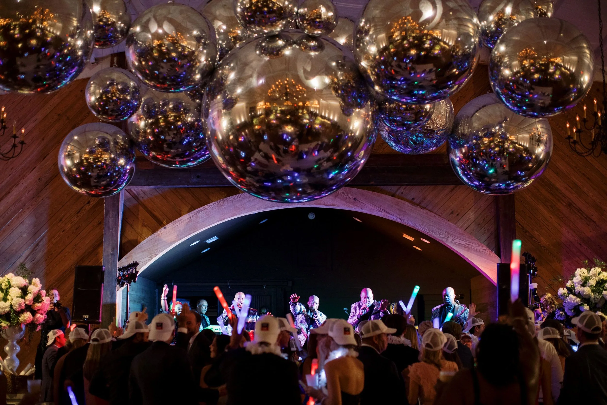 reflective orb floral chandelier hanging above dance floor in grand hall jefferson oxford wedding.jpg