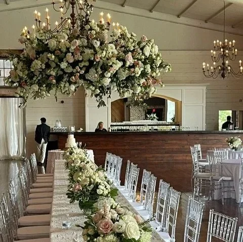 floral chandelier hanging above the head table during a wedding reception at The Jefferson Oxford