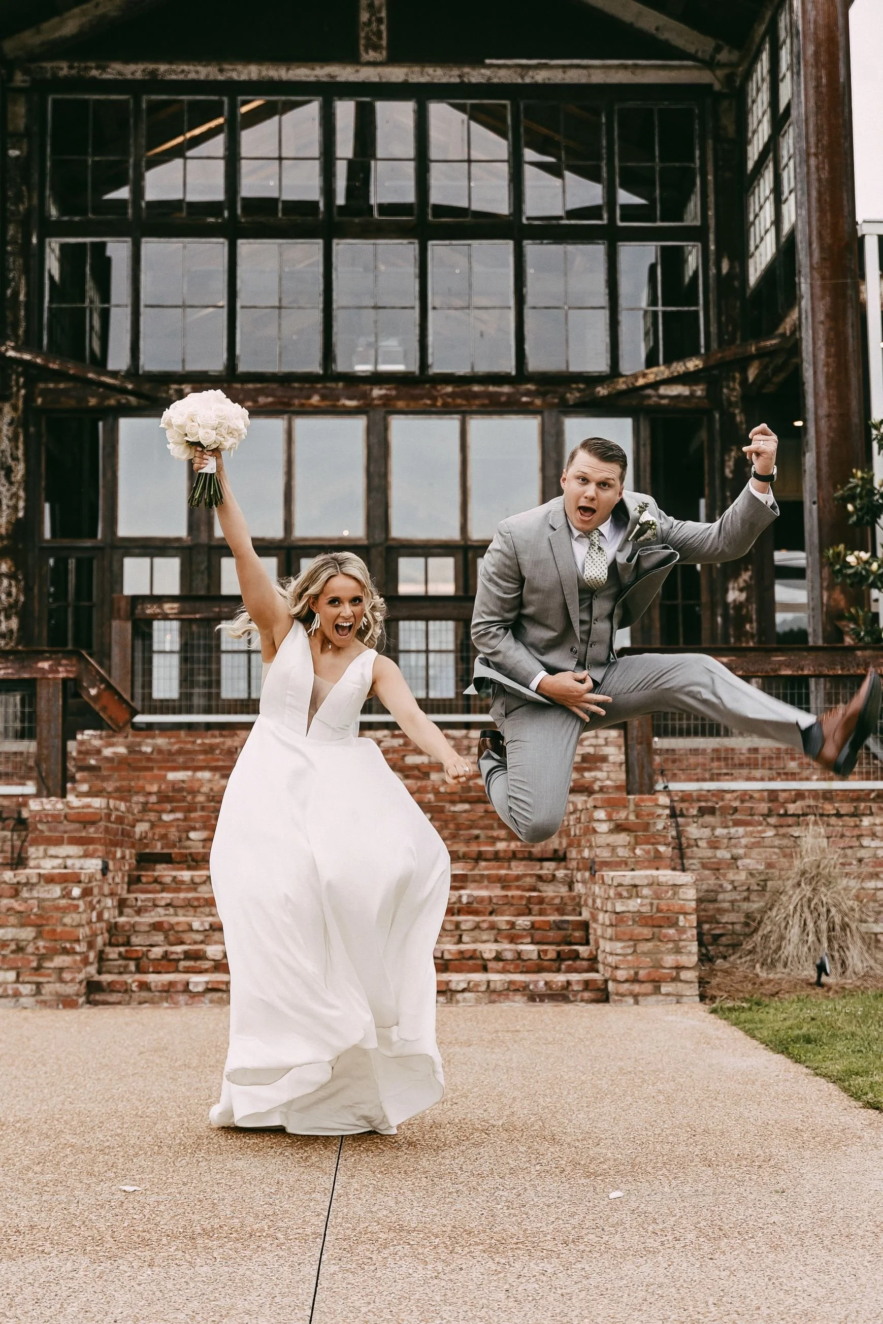 couple leaping for joy wedding reception jefferson oxford ms