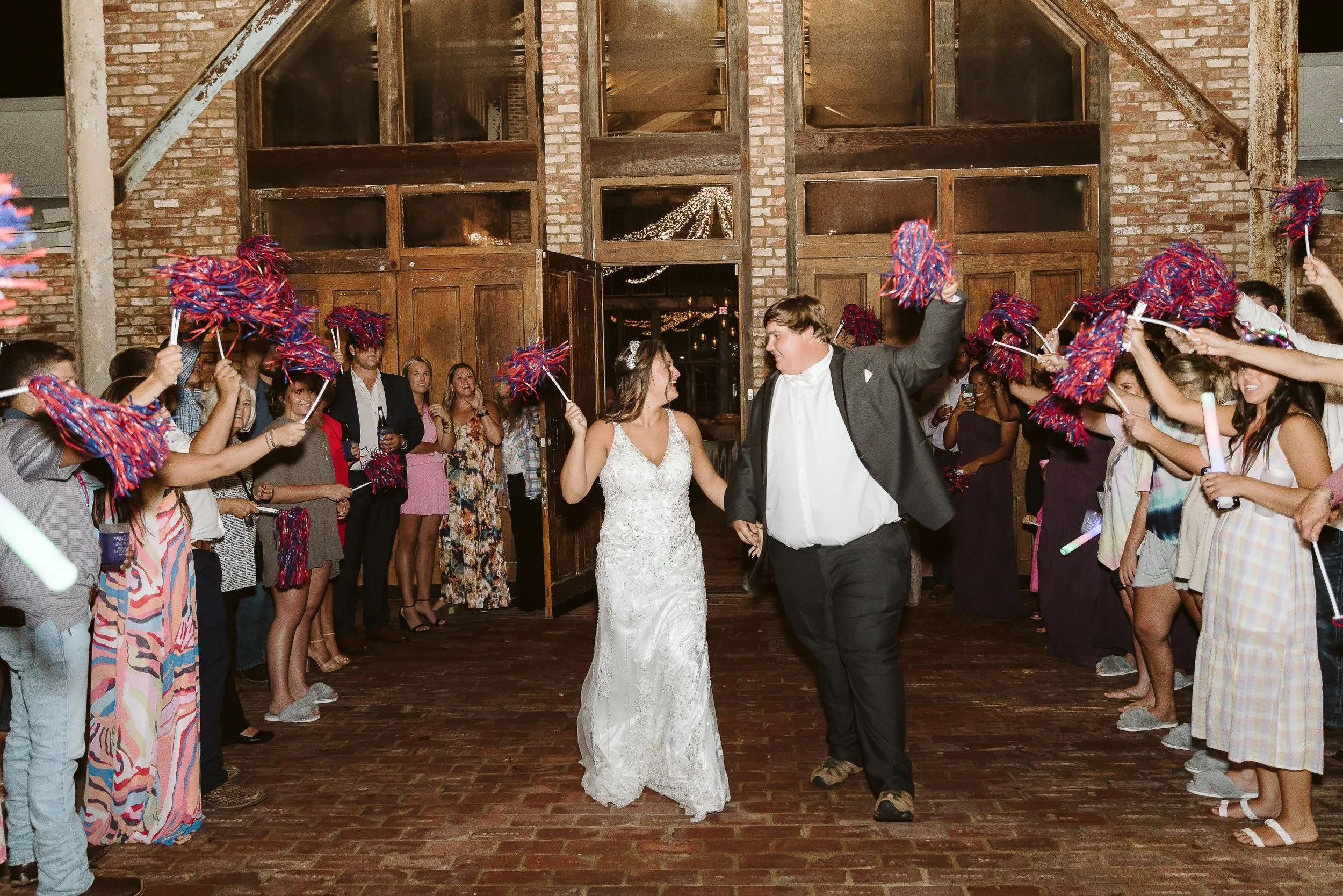 crowd shaking pom poms for wedding send-off at the jefferson oxford
