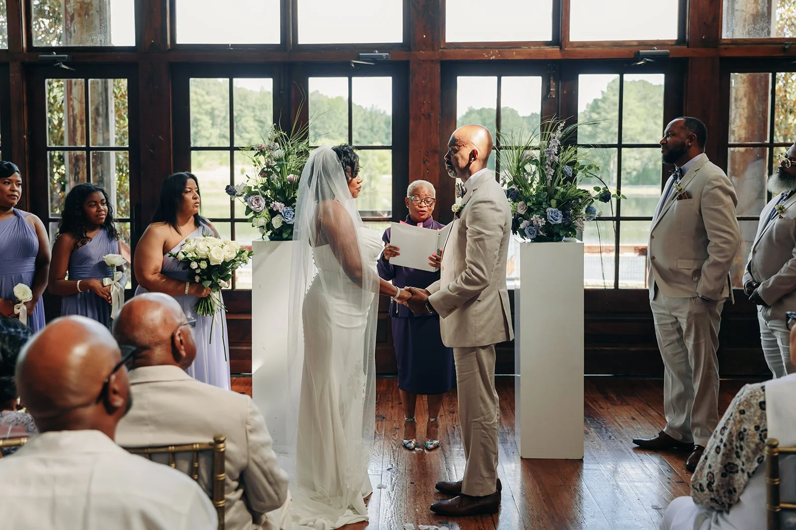 couple in Faulkner Room wedding ceremony with florals at Jefferson Oxford