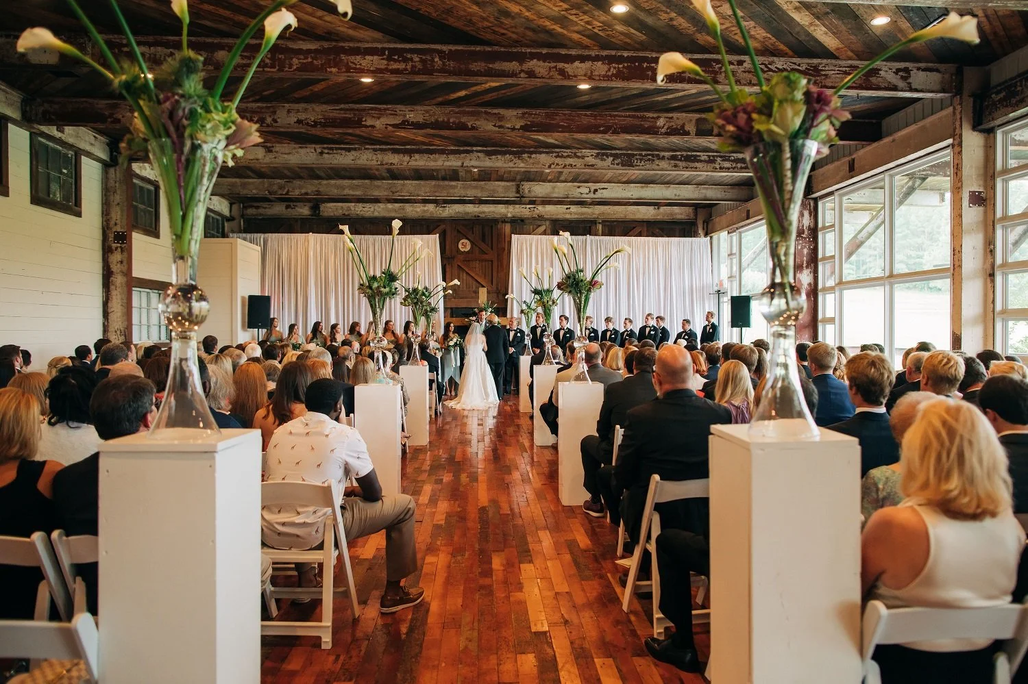 wedding ceremony in lakeside room with white draping & orchids at The Jefferson Oxford