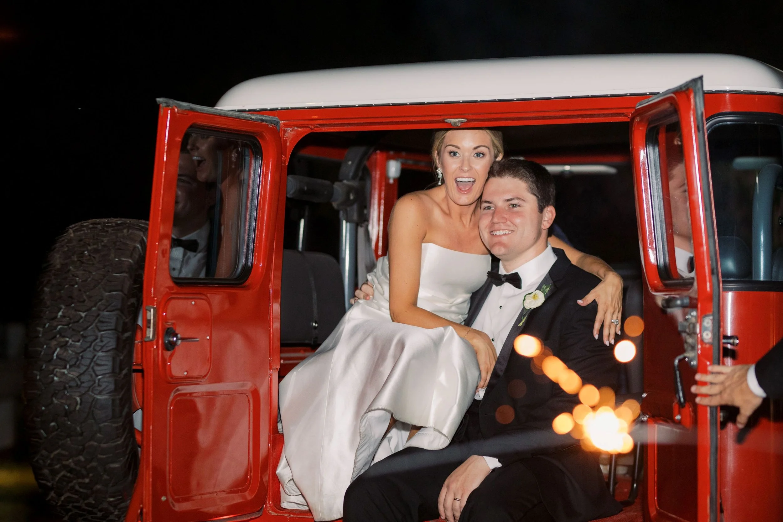 bride and groom inside back of getaway car wedding send-off at the jefferson Oxford
